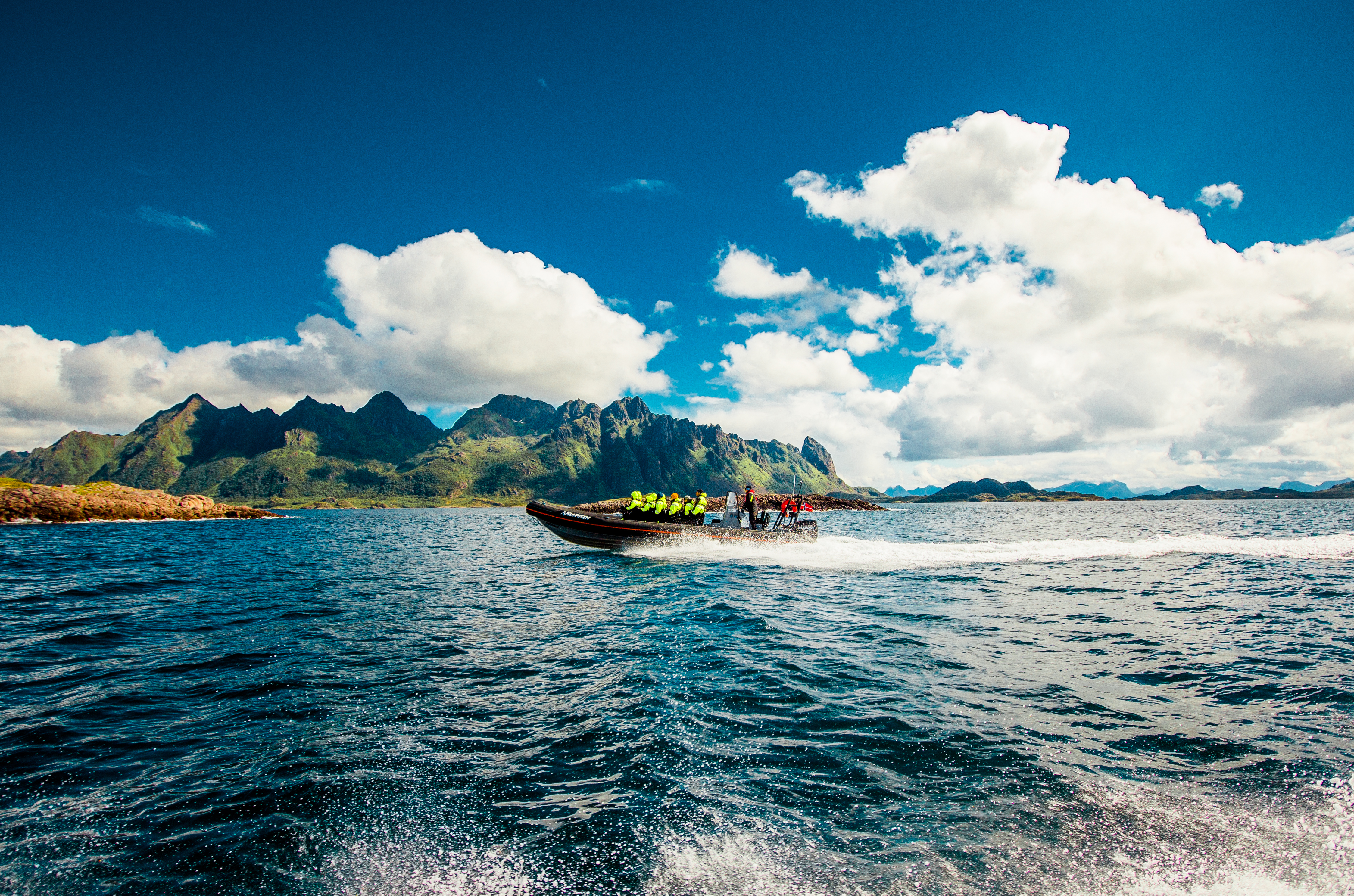 RIB boat in full speed along the coast of Lofoten